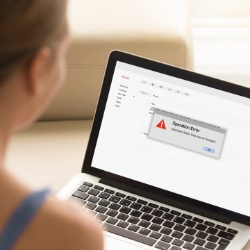 woman on laptop error on screen restoro system optimizers